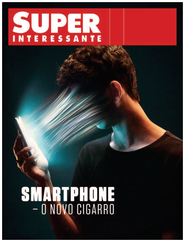 Capa da revista SUPER INTERESSANTE, com o título da revista em branco sobre uma faixa vermelha. Um homem de camiseta preta segura um smartphone diante do rosto; feixes luminosos saem da tela em direção ao rosto, que aparece distorcido e puxado para o aparelho. Na parte inferior, lê-se “SMARTPHONE – O NOVO CIGARRO”.