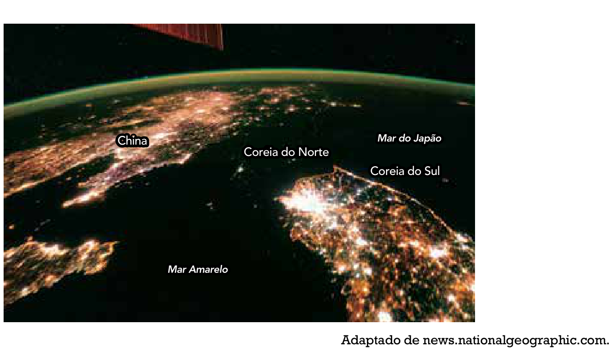 Imagem noturna de satélite mostrando a Península Coreana e áreas vizinhas: a Coreia do Sul e partes da China aparecem fortemente iluminadas, enquanto a Coreia do Norte aparece quase que totalmente na escuridão, destacando-se apenas um ponto de luz correspondente à capital Pyongyang. Os mares Amarelo e do Japão também estão indicados.