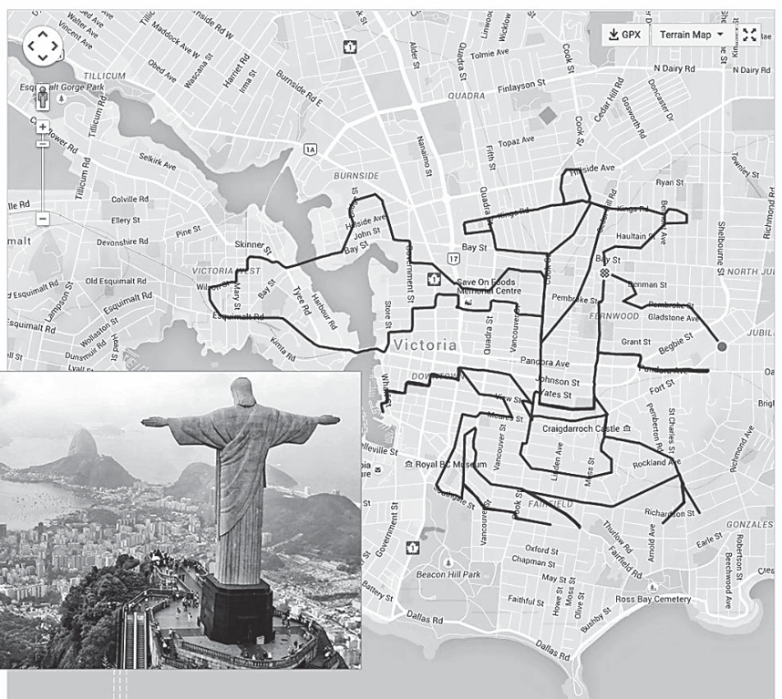 Mapa da cidade de Victoria com uma rota percorrida que delineia o formato da estátua do Cristo Redentor; no canto inferior esquerdo, fotografia da estátua do Cristo Redentor no Rio de Janeiro vista de costas e de perfil.