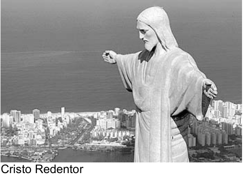 Fotografia do Cristo Redentor, de braços abertos, com a cidade e o mar ao fundo. Legenda: Cristo Redentor.