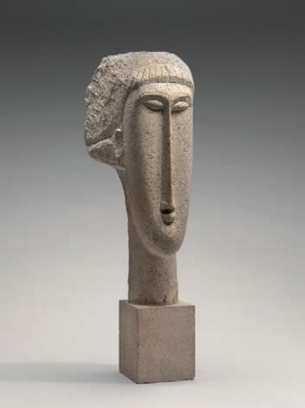 F2 Escultura modernista em calcário de Amedeo Modigliani representando uma cabeça de mulher bastante alongada, com traços faciais geométricos e estilizados, apoiada sobre uma base quadrada.
