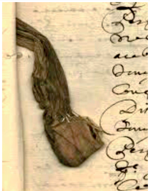 Bolsa de mandinga anexada a um manuscrito com caligrafia antiga