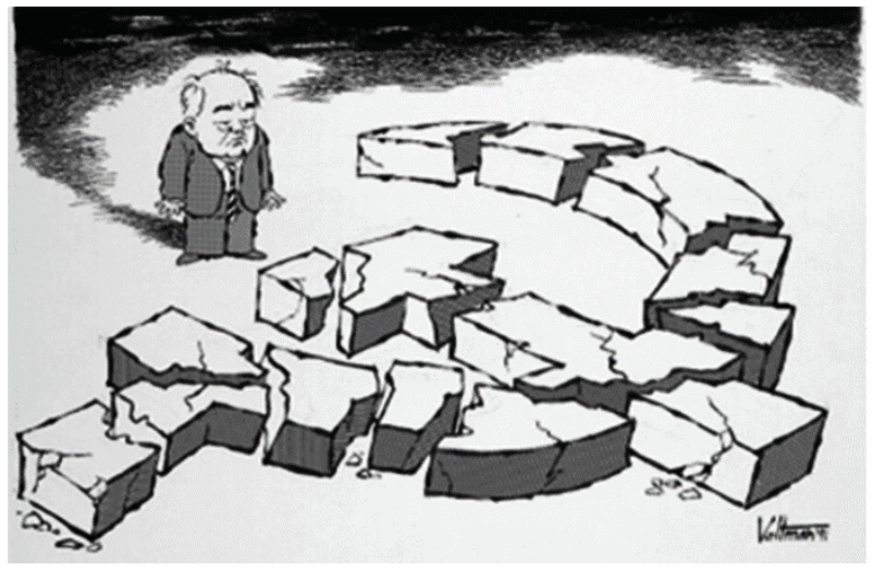 Charge de Edmund S. Valtman retratando Mikhail Gorbachev de pé, com expressão abatida, diante dos símbolos da foice e do martelo esculpidos em blocos de pedra partidos e caídos pelo chão.